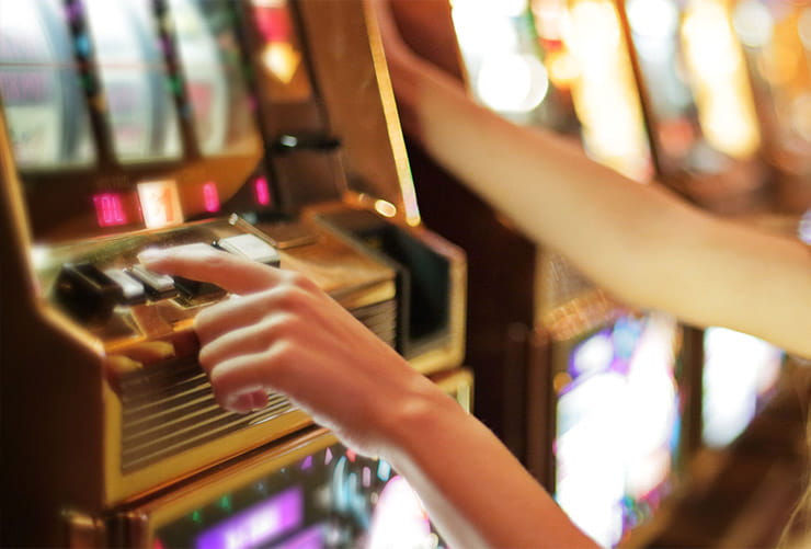 A woman playing a slot machine.
