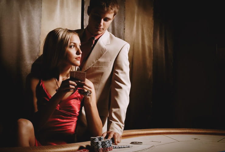 A man and a woman playing blackjack together.