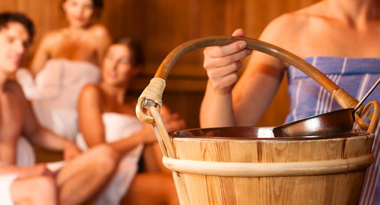 A group of people sitting in a sauna.