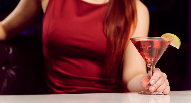 A woman drinking a cocktail.