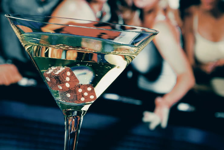A martini glass with craps dice inside.