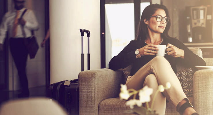 A woman sips coffee.