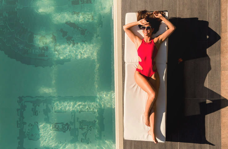 A woman lounging by the pool.